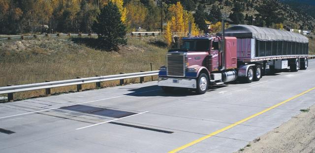 Truck approaching a Weigh-in-Motion (WIM) system on a pavement